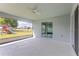 The screened patio has a ceiling fan and sliding glass doors to the home and backyard at 30505 Island Club Dr., Deer Island, FL 32778