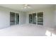 The screened patio has a ceiling fan and sliding glass doors to the home and backyard at 30505 Island Club Dr., Deer Island, FL 32778