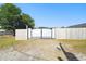 Back gate offering access to the property, surrounded by a wooden fence for added privacy at 4889 Myrtle View N Dr, Mulberry, FL 33860