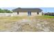 Backyard of home with a patio door and windows, offering outdoor living and natural light at 4889 Myrtle View N Dr, Mulberry, FL 33860