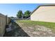 Expansive backyard with a mix of grass and bare ground, bordered by a wooden fence at 4889 Myrtle View N Dr, Mulberry, FL 33860
