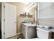Bright bathroom features a white vanity, a large mirror, and a toilet near a window at 4889 Myrtle View N Dr, Mulberry, FL 33860