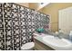The bathroom includes a vanity and toilet adjacent to the shower with a bold geometric curtain at 4889 Myrtle View N Dr, Mulberry, FL 33860