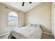 Cozy bedroom features a vaulted ceiling, window with blinds, and neutral decor at 4889 Myrtle View N Dr, Mulberry, FL 33860