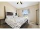 Bedroom boasts a queen-sized bed with floral bedding, vaulted ceiling, and a bright window at 4889 Myrtle View N Dr, Mulberry, FL 33860