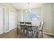 Bright dining area with wood-look flooring, a chandelier, and a large arched window at 4889 Myrtle View N Dr, Mulberry, FL 33860