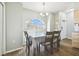 Bright dining area with wood-look flooring, a chandelier, and a large arched window at 4889 Myrtle View N Dr, Mulberry, FL 33860