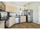 Modern kitchen features stainless steel appliances, light wood cabinetry, and a window pass-through at 4889 Myrtle View N Dr, Mulberry, FL 33860