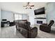 Comfortable living room features a stone fireplace, a ceiling fan, and tile floors at 4889 Myrtle View N Dr, Mulberry, FL 33860