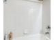 This renovated shower features white tiles and modern fixtures at 4889 Myrtle View N Dr, Mulberry, FL 33860