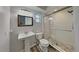 Updated bathroom featuring a glass shower door, a pedestal sink, wood-look tile floors, and natural light at 66 Alachua Dr, Winter Haven, FL 33884