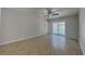 Bedroom featuring tile flooring, a ceiling fan, and a sliding glass door to the pool at 66 Alachua Dr, Winter Haven, FL 33884