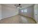 This bedroom is complete with modern ceiling fan and neutral tile flooring and a large window for natural light at 66 Alachua Dr, Winter Haven, FL 33884