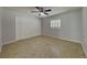 Bedroom featuring neutral paint, tile flooring, ceiling fan, and a window allowing natural light to flow through at 66 Alachua Dr, Winter Haven, FL 33884