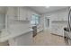 Modern kitchen featuring quartz countertops, stainless steel appliances, and sleek white cabinetry at 66 Alachua Dr, Winter Haven, FL 33884