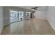 Open living area with tile floors, light gray walls, ceiling fan, and sliding door at 66 Alachua Dr, Winter Haven, FL 33884