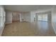Open-concept living room with tile flooring and sliding glass doors leading to the outdoors at 66 Alachua Dr, Winter Haven, FL 33884
