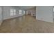 Spacious living room featuring neutral walls, tile flooring, and bright windows at 66 Alachua Dr, Winter Haven, FL 33884