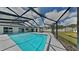 A clear blue screened-in pool with a covered lanai and spacious deck, perfect for outdoor living at 66 Alachua Dr, Winter Haven, FL 33884