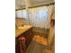 Cozy bathroom featuring a wood vanity and a patterned shower curtain at 8955 Rhoden Loop W Rd, Fort Meade, FL 33841