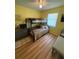 Bright bedroom features a bunk bed, wood floors, and a ceiling fan at 8955 Rhoden Loop W Rd, Fort Meade, FL 33841