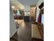 Hallway view showcasing seamless transition to the kitchen with a bench, coat rack, and an area rug at 8955 Rhoden Loop W Rd, Fort Meade, FL 33841