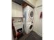 Convenient laundry area has a stacked washer/dryer and utility sink at 8955 Rhoden Loop W Rd, Fort Meade, FL 33841
