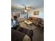 Inviting living room with dark wood floors, ceiling fan, neutral walls, and comfortable furnishings at 8955 Rhoden Loop W Rd, Fort Meade, FL 33841
