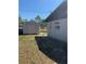 Exterior angle showing a shed and side of the house, complemented by the vast open space beyond at 8955 Rhoden Loop W Rd, Fort Meade, FL 33841
