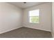 Bedroom features carpeted floor, neutral wall color, ceiling fan, and window overlooking the exterior at 2573 Carrington Ct, The Villages, FL 32162
