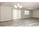 Bright dining area with modern chandelier, blinds, lots of windows and wood-look floors at 2573 Carrington Ct, The Villages, FL 32162
