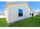 Exterior shot of property with vinyl siding, grass lawn, and views of adjacent homes at 2573 Carrington Ct, The Villages, FL 32162
