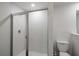 Bright bathroom featuring a tiled shower with a glass door at 591 Bay Leaf Dr, Poinciana, FL 34759