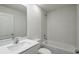 A modern bathroom featuring white tile tub surround and sleek fixtures at 607 Bay Leaf Dr, Poinciana, FL 34759