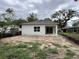 A view of the backyard features a covered patio and a large yard, ready for landscaping at 1205 Eastin Ave, Orlando, FL 32804