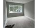Bright, unfinished bedroom with a large window providing natural light and treetop views at 1205 Eastin Ave, Orlando, FL 32804