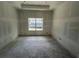 Spacious unfinished primary bedroom features a window overlooking the neighborhood at 1205 Eastin Ave, Orlando, FL 32804