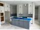 Spacious kitchen with white cabinets and a large gray island, awaiting finishing touches at 1205 Eastin Ave, Orlando, FL 32804