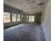 Unfinished living room with large windows and a sliding glass door that leads to the backyard at 1205 Eastin Ave, Orlando, FL 32804