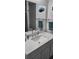 Bathroom with white quartz vanity and a large mirror featuring decorative fish art at 13378 Sw 89Th Ter, Ocala, FL 34473