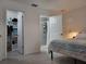 Bright bedroom featuring an ensuite bathroom and closet with shelving at 13378 Sw 89Th Ter, Ocala, FL 34473