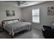 A bright primary bedroom with an accent wall and updated flooring at 13378 Sw 89Th Ter, Ocala, FL 34473