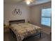 Bedroom with a bed, window with shutters, ceiling fan, and side tables at 13378 Sw 89Th Ter, Ocala, FL 34473