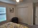 Bedroom with a closet, side table, and window with shutters at 13378 Sw 89Th Ter, Ocala, FL 34473
