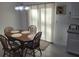Cozy dining area with a sliding glass door and wood-like tile flooring at 13378 Sw 89Th Ter, Ocala, FL 34473