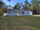 Charming single-story home with a well-maintained lawn, blue exterior and new roof at 13378 Sw 89Th Ter, Ocala, FL 34473