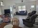 A spacious living room with tiled floors, a ceiling fan and plenty of natural light at 13378 Sw 89Th Ter, Ocala, FL 34473
