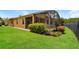 Landscaped backyard featuring a screened lanai, green lawn, and a fenced perimeter at 1405 Harbor Ridge Dr, Kissimmee, FL 34759