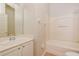 Bright bathroom with a bathtub and shower combination and single sink vanity at 1405 Harbor Ridge Dr, Kissimmee, FL 34759