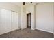 Cozy carpeted bedroom with closet and open door to another room at 1405 Harbor Ridge Dr, Kissimmee, FL 34759